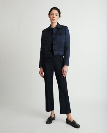 Evening blouson jacket with buttoned fly front in blue lurex with details in black mat acetate viscose crêpe. PALLAS PARIS